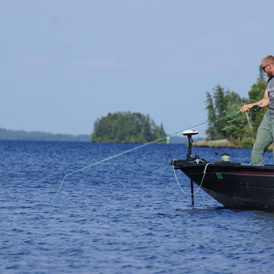 fly fishing on rainy lake for bass 